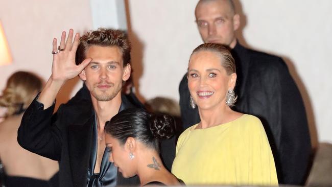 The exact moment Vanessa Hudgens walked past ex Austin Butler as he chatted with Sharon Stone outside the Vanity Fair Oscars afterparty. Picture: TPG / BACKGRID