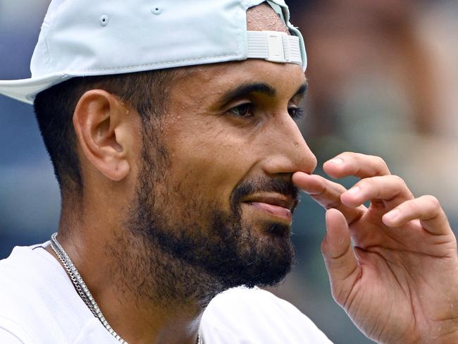 Australia's Nick Kyrgios touches his nose as he plays against Chile's Cristian Garin during their men's singles quarter final tennis match on the tenth day of the 2022 Wimbledon Championships at The All England Tennis Club in Wimbledon, southwest London, on July 6, 2022. (Photo by SEBASTIEN BOZON / AFP) / RESTRICTED TO EDITORIAL USE