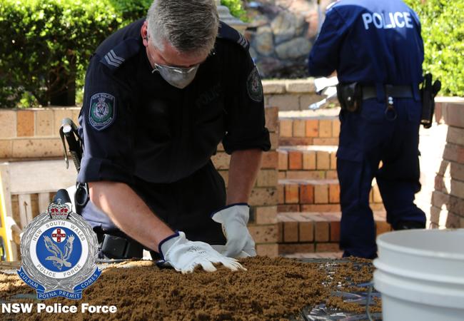 Police sift through some of the soil dug up at the former Dawson house. Picture: NSW Police