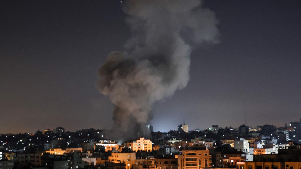 Smoke billows above buildings after an Israeli air strike on Gaza City in the Gaza Strip early on May 15, 2021. Picture: MAHMUD HAMS / AFP
