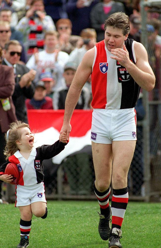 Danny Frawley runs out with one his daughters ahead of his last game.