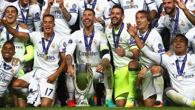 Real Madrid celebrates with the UEFA Super Cup trophy.