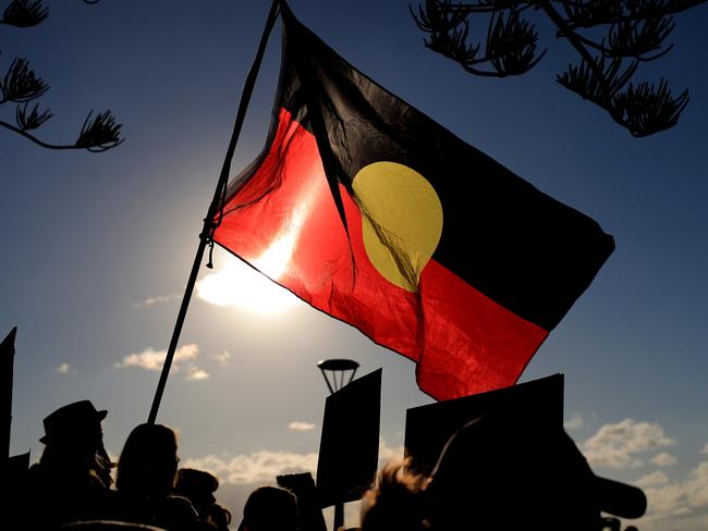 An Aboriginal flag flies over the Protest march and gathering at Byron BAy for Back Lives Matter. Photo Scott Powick Newscorp