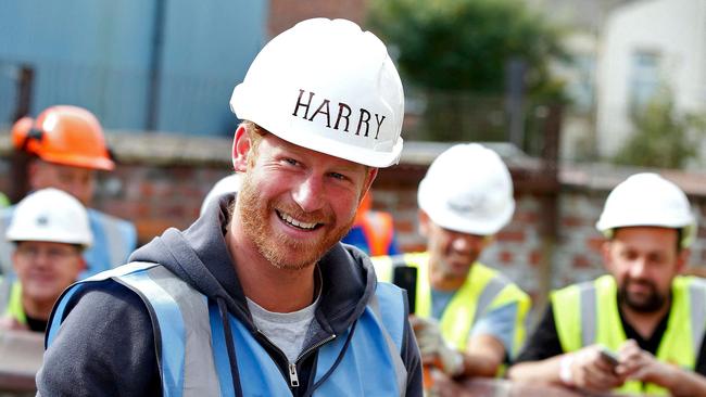 Prince Harry prepares to lay paving slabs in Manchester in 2015, as part of his visit with his brother the Duke of Cambridge to the BBC's DIY SOS television show helping to renovate homes for ex-service personnel.