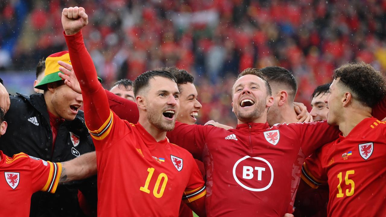 Wales players celebrate after qualifying for the World Cup.