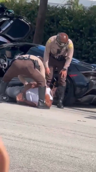 Video footage shows Tyreek Hill outside his car getting handcuffed by police