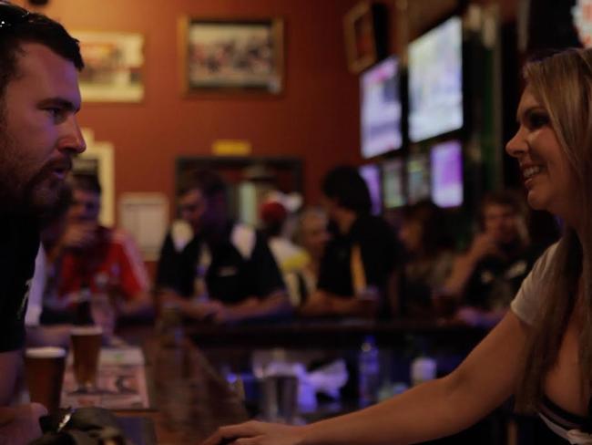 Outback town ... bartender Courtney chats to a punter.