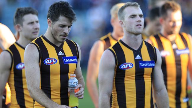 Isaac Smith and Tom Mitchell walk off the ground after losing to St Kilda.