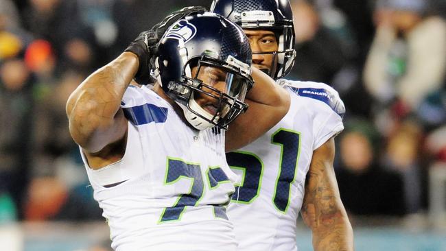 Michael Bennett #72 of the Seattle Seahawks celebrates a sack against Mark Sanchez #3.