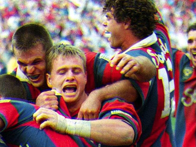 ADDITIONAL RATES MAY APPLY FOR USE OF IMAGE. Rugby League-ARL Grand Final 1997. Darren Albert (centre) is mobbed and congratulated after his match winning last gasp try . Grand Final, Manly v Newcastle at the SFS , Sunday September 28th 1997. (AAP Image/Robb Cox) NO ARCHIVING