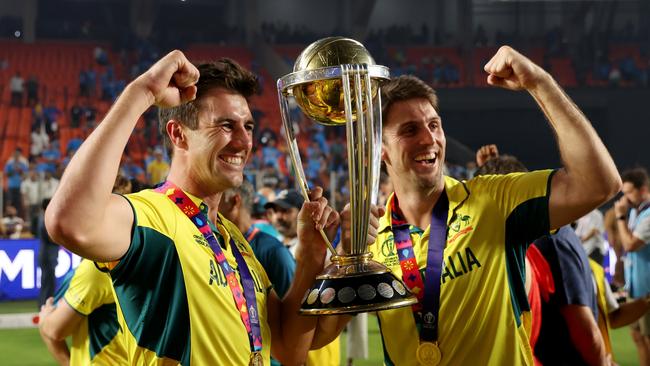 AHMEDABAD, INDIA - NOVEMBER 19: Pat Cummins and Mitch Marsh of Australia pose with the ICC Men's Cricket World Cup Trophy following the ICC Men's Cricket World Cup India 2023 Final between India and Australia at Narendra Modi Stadium on November 19, 2023 in Ahmedabad, India. (Photo by Robert Cianflone/Getty Images)