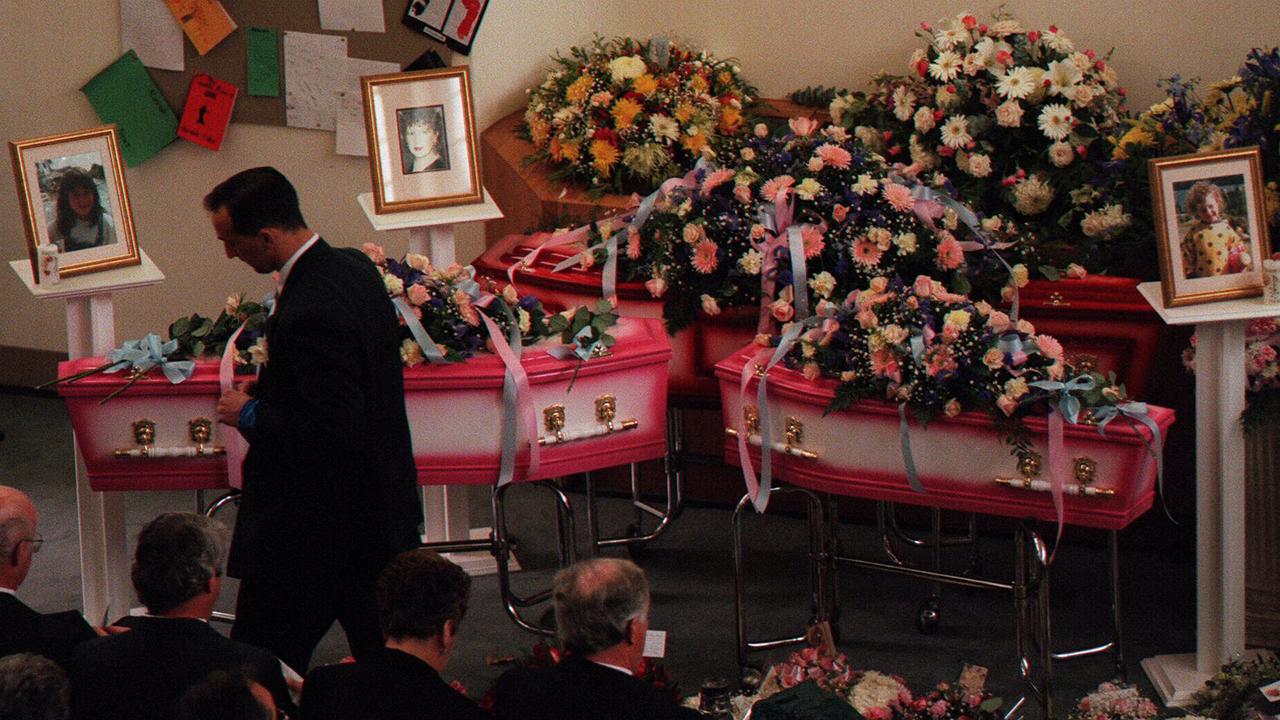 Walter Mikac stands by the coffins of his wife Nanette and his daughters Alannah, 6, and Madeline, 3.