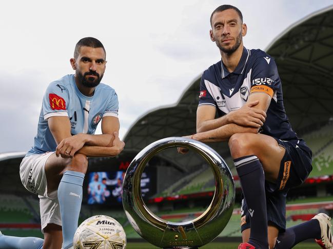 City captain Aziz Behich and Victory skipper Roderick Miranda with the A-League men’s trophy ahead of the grand final. Picture: Michael Klein