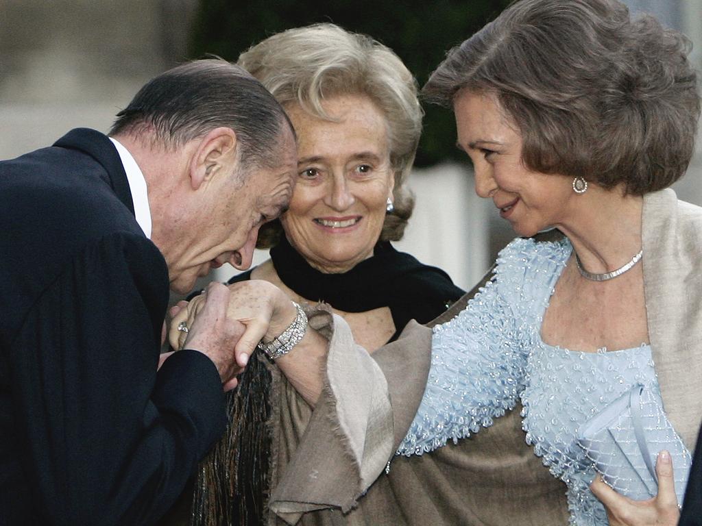 French President Jacques Chirac, left, kisses the hand of Spanish Queen Sofia as his wife Bernadette Chirac, centre, looks on. Picture: AP Photo/Francois Mori, File.