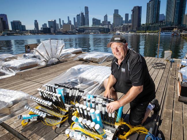 Pyrotechnician Rusty Johnson putting the finishing touches on the fireworks at Docklands. Picture: Mark Stewart