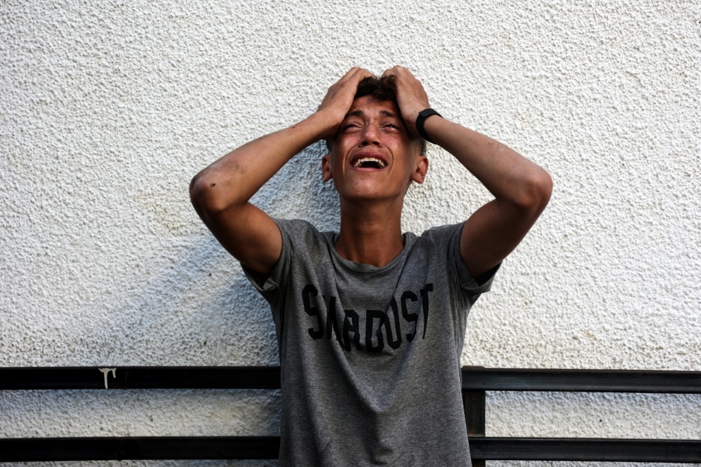 A Palestinian youth reacts after having relatives killed in an Israeli air strike in Jabalia, northern Gaza