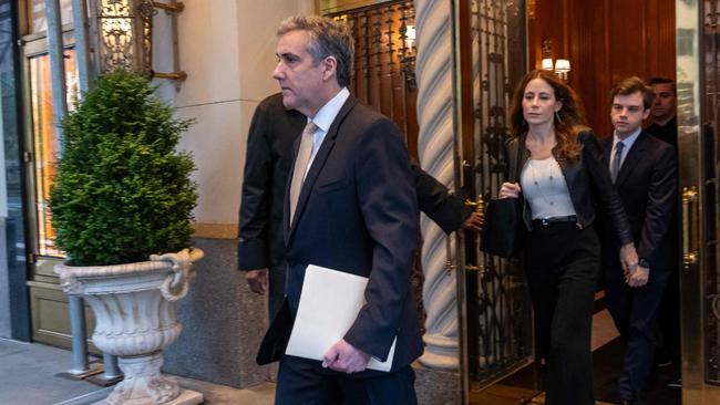 Michael Cohen, former personal lawyer to Donald Trump, and lawyer Danya Perry leave his apartment building on his way to the Manhattan Criminal Court on Thursday. Picture: Getty Images