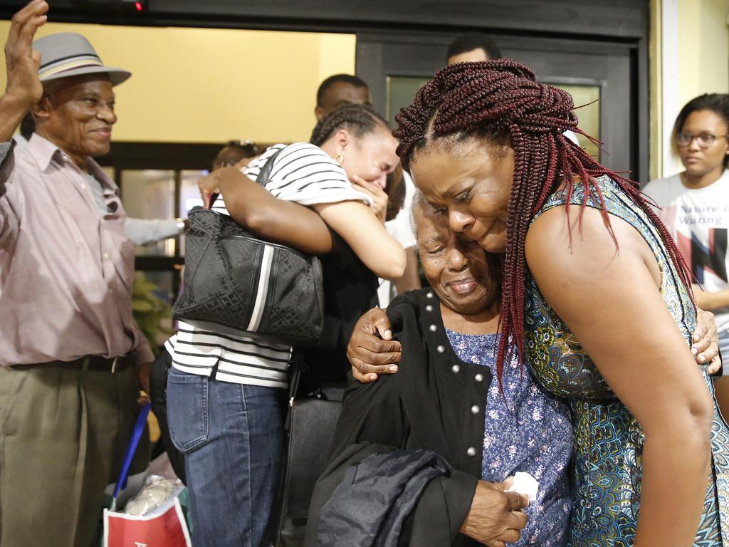 Jasmine Farrington, right, greets Martha Eyma after being rescued and flown from devastated Abaco Island to Nassau, Bahamas. Picture: Getty Images