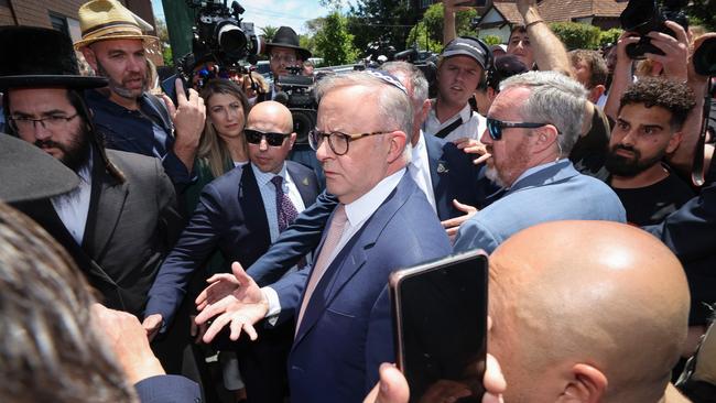 The PM was rushed by crowds leaving from a side door of the Synagogue still wearing the Kippah after a meeting with community leaders. Picture: David Caird