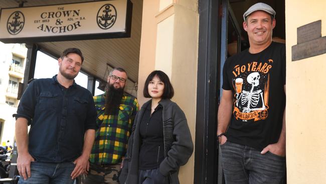 Proprietor Tom Skipper (right) with Crown &amp; Anchor supporter group members Liberty Li, Dan Bogan Kirk, and Evan Morony. Picture: Dean Martin