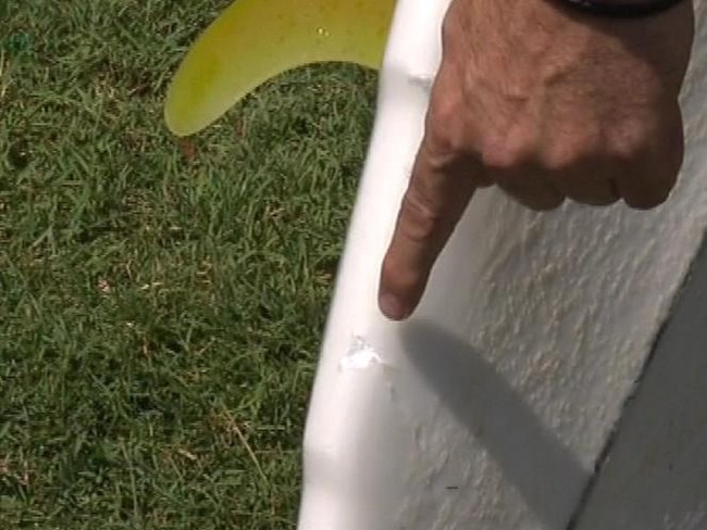 ***MUST CREDIT 7 News*** large shark teeth marks can be seen on Lee Jonsson's surfboard. Mr Jonsson was attacked at Ballina