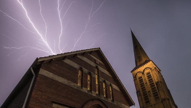 Lightning strikes over St Mark's Anglican Church in Camberwell on Friday evening. Picture: Alex Coppel.