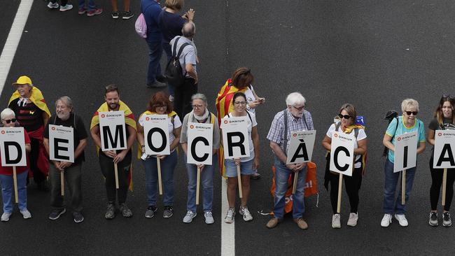 Protesters march with a letters reading “democracy”. Picture: AP