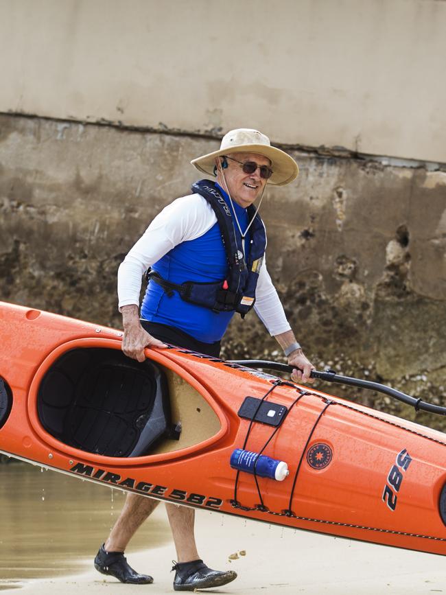 The PM walks his kayak up the beach. Picture: Jenny Evans