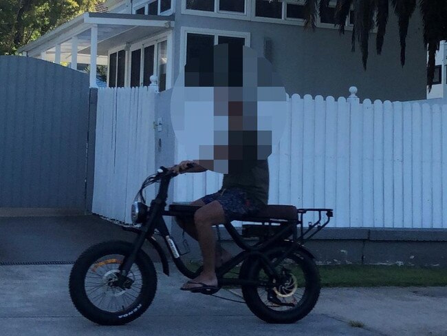 A man, wearing thongs and no helmet, on an e-bike on the shared path along Pittwater Rd, Manly. Picture: Jim O'Rourke