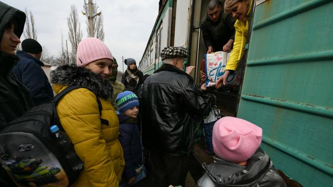 Civilians, with their belongings, queue in front of the gate of a train compartment to flee to the Rostov region, in the self-proclaimed so-called Donetsk People's Republic. Picture: Getty