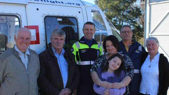 Schofields crash victim Laurel Mitchell, fourth left with daughter Sienna, her dad Dennis Mitchell, bus driver Allan Fleming, pilot John Hoad, Dr Peter Clark and mum Margaret Mitchell. Picture: CareFlight