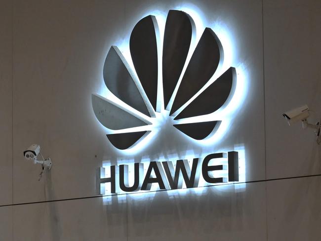 In this picture taken on May 29, 2019, a company logo is displayed at a reception area at the Huawei headquarters in Shenzhen, China's Guangdong province. - Huawei's main Shenzhen campus is a sprawling, lavishly landscaped mix of glass office towers, labs and training centres, including a white-columned neo-classical research site the size of a city block and cheekily dubbed the "White House" for its resemblance to US President Donald Trump's current address. (Photo by HECTOR RETAMAL / AFP) / To go with China-US-trade-Huawei-telecommunication, SCENE by Dan Martin