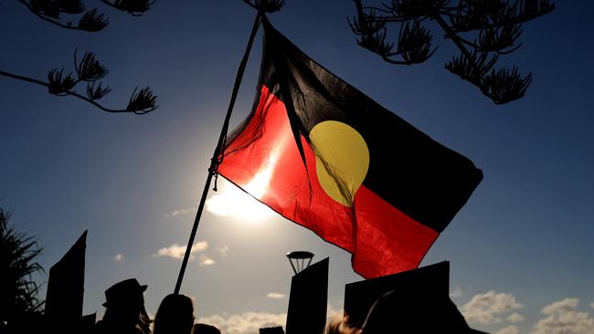 An Aboriginal flag flies over Black Lives Matter protest march. Picture: Scott Powick