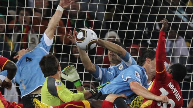 Luis Suarez handballs to stop a Ghana goal during the 2010 World Cup.