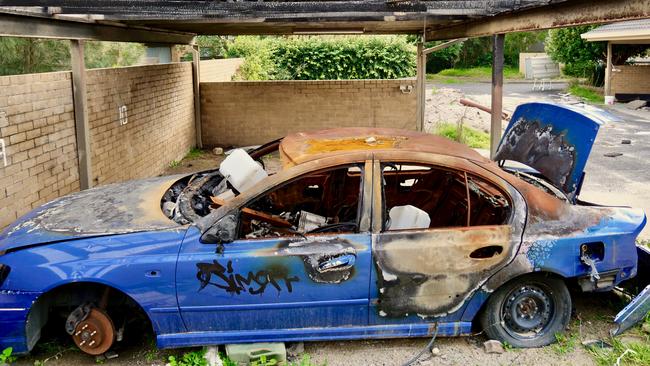 A rusted-out and partly burnt abandoned car at the former Berkeley Living retirement village.