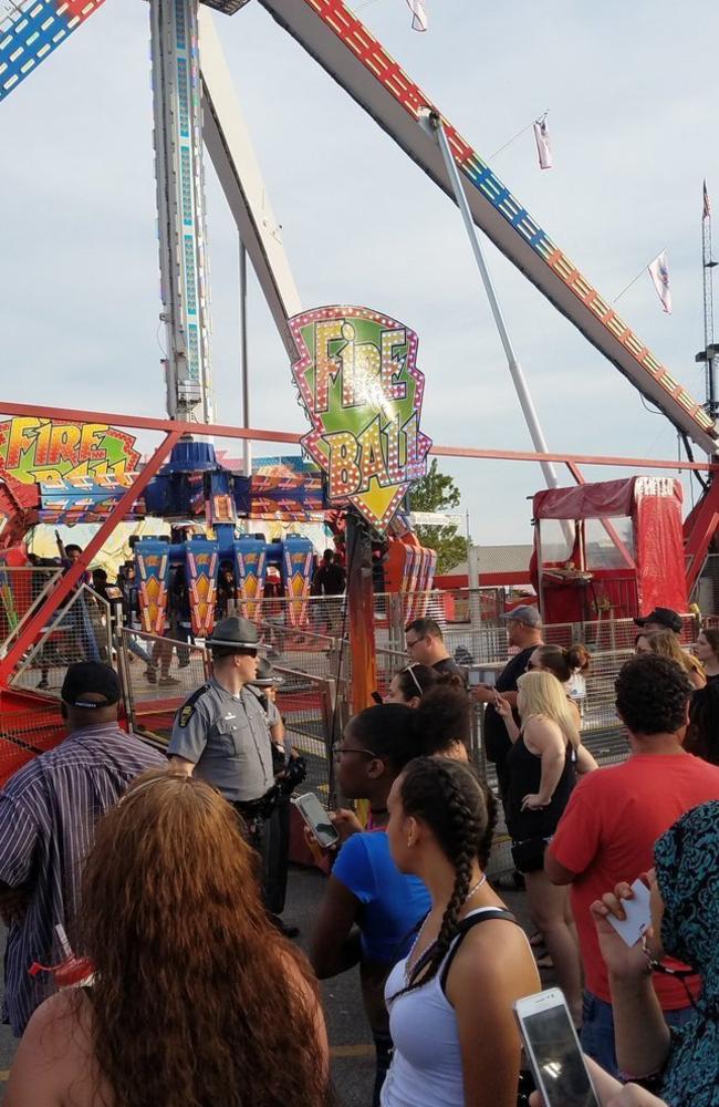 People watch as authorities respond near the Fire Ball ride in the wake of the accident. Picture: Justin Eckard via AP