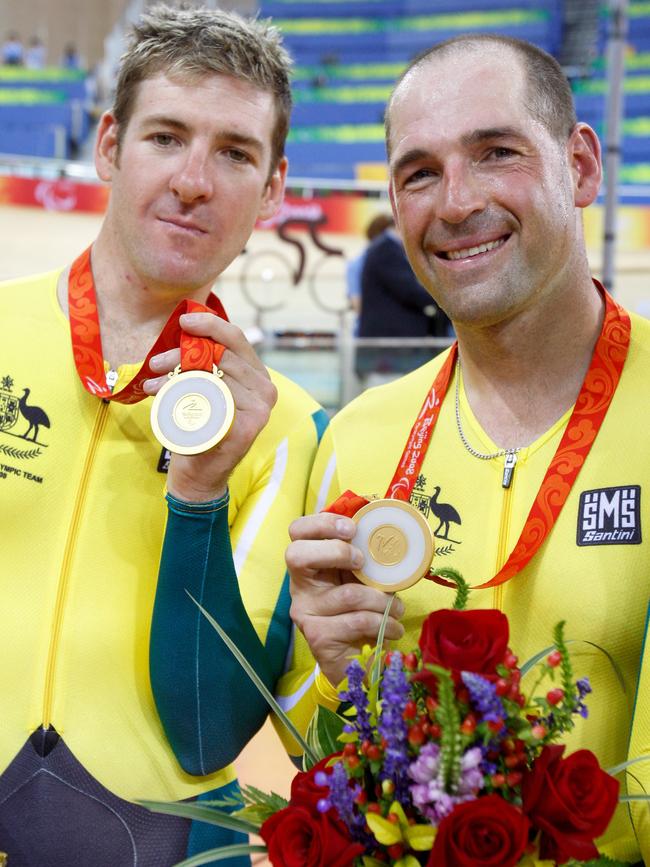 Kieran Modra, right, and his co-cyclist Tyson Lawrence, with their gold medals won for the 4000m individual pursuit at the Beijing Paralympic Games in 2008. Modra and Lawrence broke the world record at 4 minutes, 18.961 sec. Picture: AP / Andy Wong