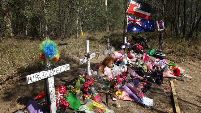 A roadside shrine on the Pacific Motorway at Coomera for the 5 people killed last weekend was moved to the adjoining Foxwell Road behind the scene. Pics Tim Marsden