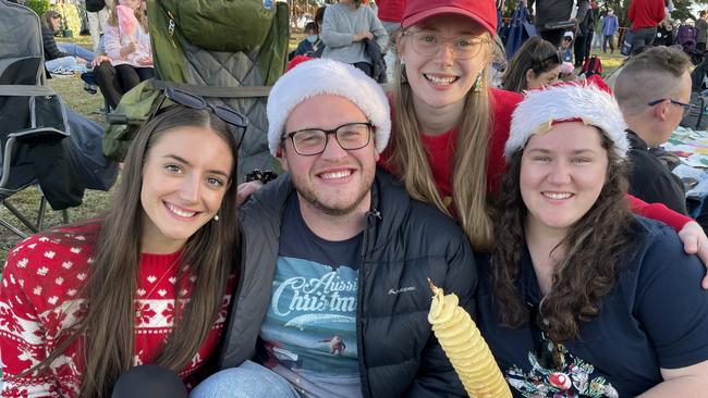 Thomastown's Chara Wilson, Shannon Wilson, Jake Cleave and Geelong's Madey Lakey enjoy Manningham's 2022 Carols at Ruffey Lake Park.