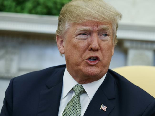 FILE - In this March 15, 2018, file photo, President Donald Trump talks with reporters during a meeting in the Oval Office of the White House in Washington. Trump is questioning the impartiality of Robert Mueller's investigation and says the probe is groundless, while raising doubts about whether a fired top FBI official kept personal memos outlining his interactions with Trump. (AP Photo/Evan Vucci, File)