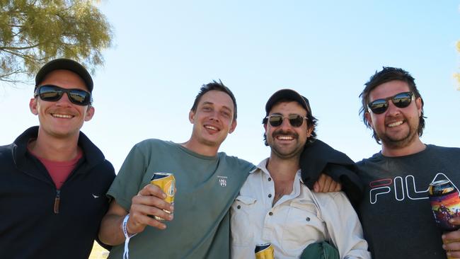 Jared Stewart, Troy Gamble, Chris Jenour and Beau Bowron all travelled down from Darwin for Finke. Camping out at Deep Well, they say Finke is "Bloody Fun." Picture: Gera Kazakov