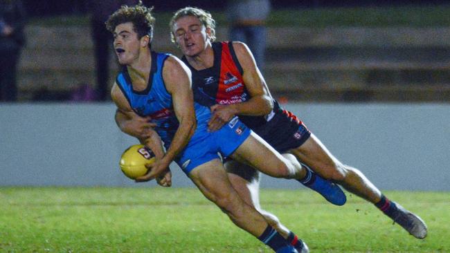 Josh Hone gets a handball away for Sturt as he is tackled by West Adelaide’s Elliot Dunkin. Picture: Brenton Edwards