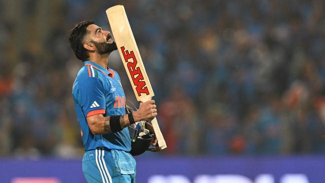 India's Virat Kohli celebrates after scoring a century. Photo by Punit PARANJPE / AFP