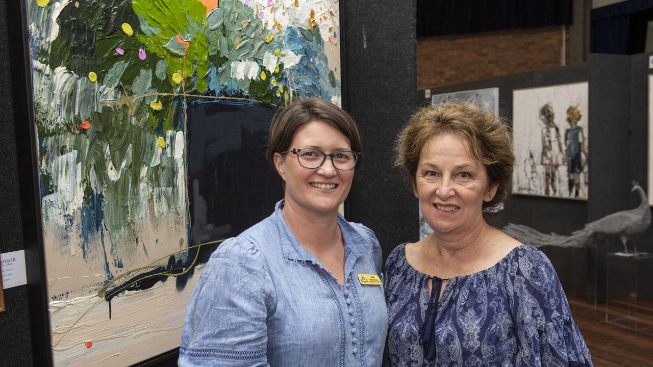 President of Grammar Art Show Committee Jodie Humphreys and Pam Brown in front of "Flowers" by artist Jess Baker at the Toowoomba Grammar School Art Show. Saturday, March 25, 2023. Picture: Nev Madsen.