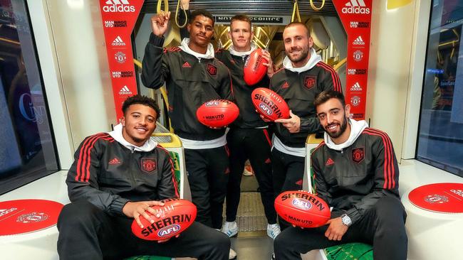 Manchester United players Jadon Sancho , Marcus Rashford , Scott McTominay , Luke Shaw and Bruno Fernandez board a tram in Melbourne before heading to greet fans at Federation Square. Picture: Ian Currie