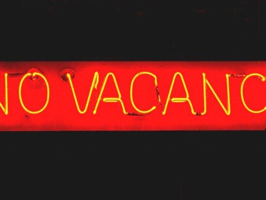 Red neon sign of "No Vacancy" at night