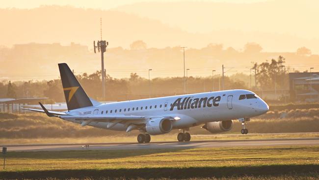 The first Alliance Aviation Embraer 190 lands at Brisbane airport, before taxiing away for a deep clean. Picture: Lyndon Mechielsen.