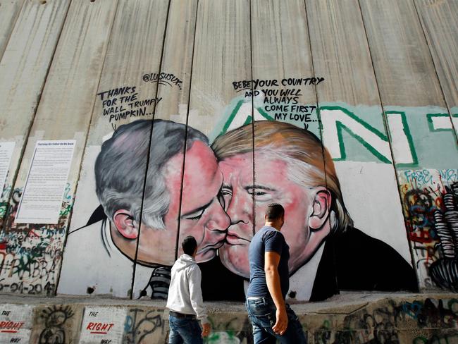 Lushsux’s work depicting US President Donald Trump kissing Israeli Prime Minister Benjamin Netanyahu. Picture: AFP/Musa Al Shaer