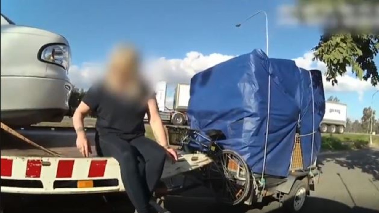 A woman has been caught trying to cross the border into Queensland by hiding inside the boot of a car on a tow truck.