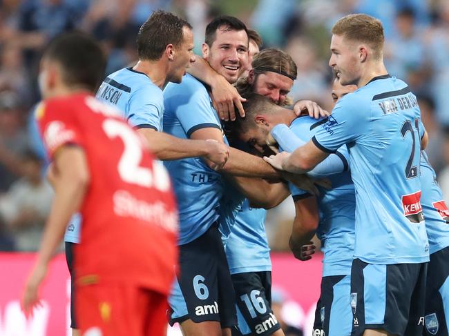 Paulo Retre’s teammates gather around their striker after scoring a goal.